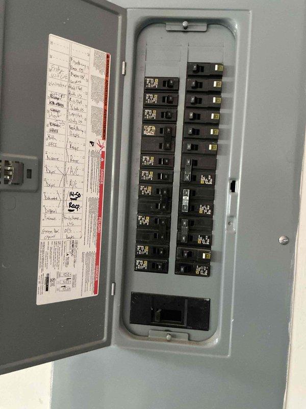 Completed HVAC system installation including gas line connections with shut-off valves and integrated electronic control unit mounted in utility space. Established electrical service by connecting new circuit breakers in main panel to support system operation, with all connections tested and verified operational.