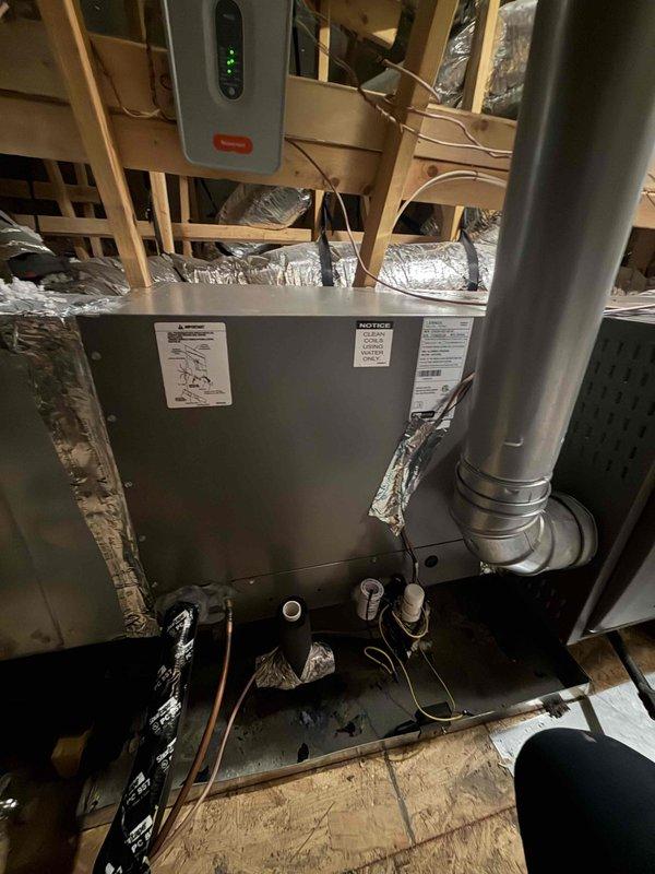 Replaced failed evaporator coil in attic air handler under Peace of Mind agreement. Two technicians completed the installation of new Mitsubishi coil assembly, reconnected all electrical wiring and refrigerant lines, and verified proper system operation. Unit tested successfully with all controls functioning as designed.