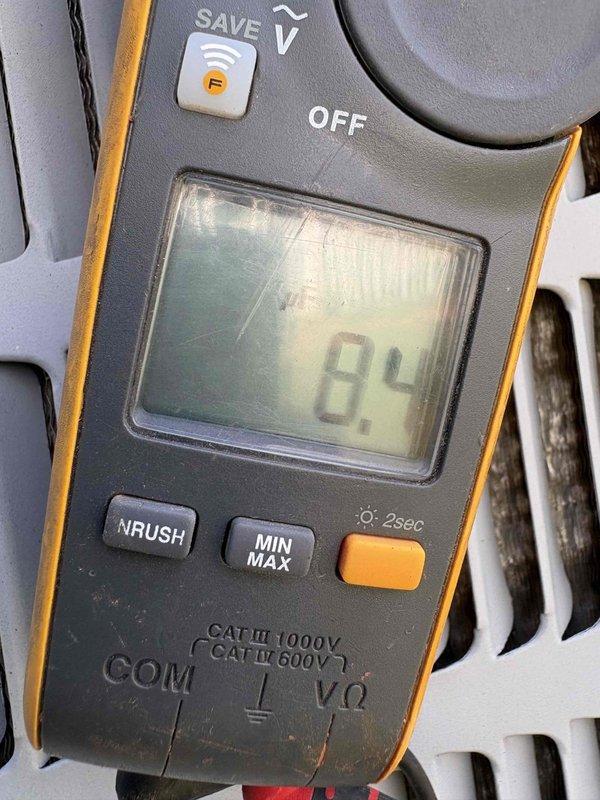 Responded to no cooling complaint on 2019 system with air handler running but no cold air output. Upon inspection, found low amperage draw of 8.4 amps at outdoor unit, indicating compressor failure or refrigerant loss. Visual examination revealed significant oxidation and corrosion on copper refrigerant lines and coil connections, suggesting potential refrigerant leak at evaporator coil assembly. Documented equipment condition with photos and provided customer with repair options for restoring cooling operation.