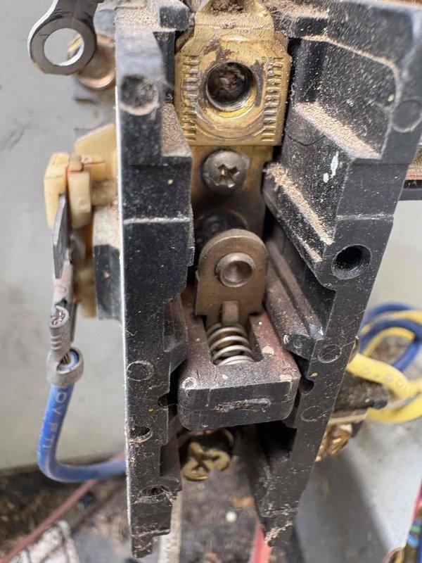 Responded to no cooling complaint on 24-year-old system. Upon arrival, confirmed unit was blowing air but not cooling. Inspected attic-mounted air handler and associated ductwork. Examined electrical connections, contactor assembly, and control components. Documented existing equipment configuration including silver metallic supply duct, black flexible return ductwork, condensate drainage system with PVC piping, and mounted control box. System showed age-appropriate wear on mechanical components including contactor housing with visible oxidation on brass elements and surface deterioration on painted surfaces. Photographed equipment for service records.