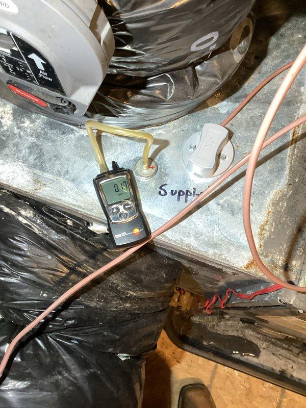 # HVAC No Cool Service Call

Responded to no cooling complaint on 2020 central air system with intermittent zone damper operation. Upon arrival, confirmed thermostat calling for cooling but motorized damper failing to open, with no indicator lights illuminated on damper actuator. Inspected air handling unit and discovered blower motor assembly heavily contaminated with insulation debris and dust accumulation, restricting airflow and potentially affecting system controls. Removed blower motor from air handler for cleaning and inspection. Performed system diagnostics using digital testing equipment to verify electrical connections and control voltage at damper actuator and zone control panel. Measured supply air temperatures and verified refrigerant pressures at condensing unit. Identified failed damper actuator as root cause of intermittent operation. Cleaned blower motor assembly, removing accumulated insulation fibers and debris from motor housing and surrounding components. Checked c