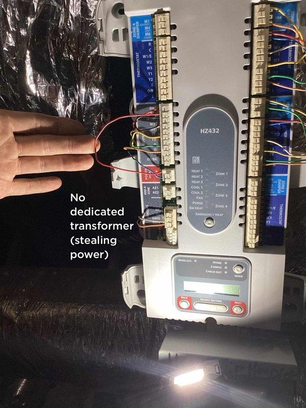Responded to service call for high indoor humidity levels (53%) and recurring mold growth in air handler unit. Performed comprehensive system inspection of 6-year-old HVAC system to diagnose moisture issues and water accumulation in drain pipe and ductwork. 

Upon inspection, identified HZ432 zone control module with improper power configuration - system operating without dedicated transformer and stealing power from thermostat circuit, which can cause intermittent operation and control issues. Examined air handler drain pan installation and condensate drainage system to assess conflicting reports from previous technicians regarding proper installation. Documented control wiring configuration showing multiple zone connections and heating/cooling circuits.

Evaluated system operation and airflow to determine contributing factors to elevated humidity levels. Assessed air handler cabinet for evidence of moisture intrusion and mold growth patterns. Inspected condensate drain line routing a