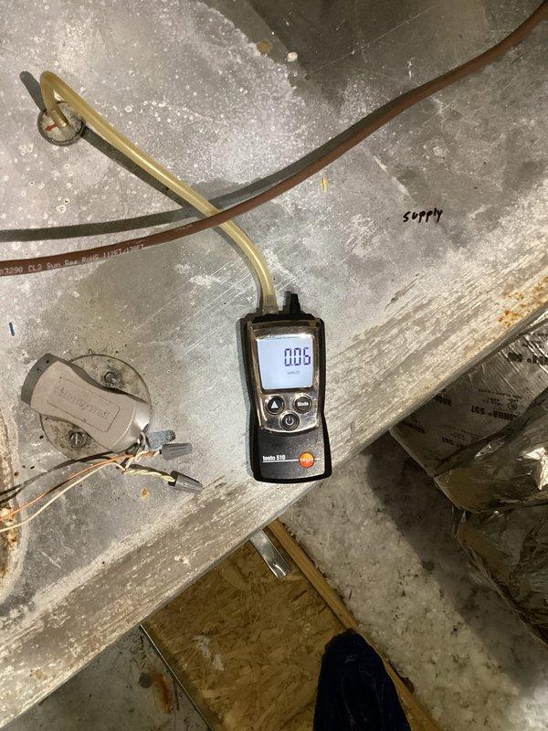 # HVAC Humidity Control Follow-Up

Responded to callback regarding persistent high indoor humidity levels reading at 60%. Previous technician had attempted to address the issue, but homeowner reported no improvement in humidity trends. 

Performed comprehensive system diagnostics using calibrated digital instruments. Measured static pressure readings on both supply and return air plenums using Testo 510 differential pressure gauge. Supply side registered 0.05" w.c. and return side measured 0.27" w.c., indicating potential airflow restrictions or system imbalance affecting dehumidification performance.

Inspected ductwork connections, refrigerant lines, and system components in mechanical space. Evaluated copper refrigerant piping routing and connections for proper installation and insulation. Assessed condensate drainage system operation to ensure proper moisture removal from evaporator coil.

Documented current system conditions with detailed measurements and photographic evidence of 