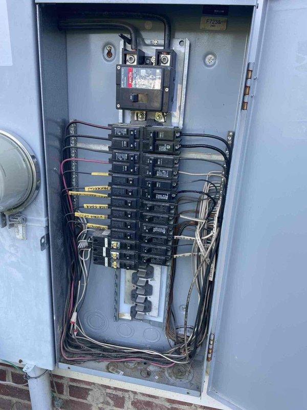 Performed diagnostic assessment of exterior lighting system at 2007-built residence. Evaluated three non-functional motion-sensor flood lights, inadequate garage-mounted fixture approximately 20 feet high requiring extended ladder access, and insufficient back door lighting. Inspected electrical panel and circuit breaker configuration to verify power supply to exterior lighting circuits. Provided recommendations for high-lumen replacement fixtures to address brightness deficiencies at garage and back door locations.