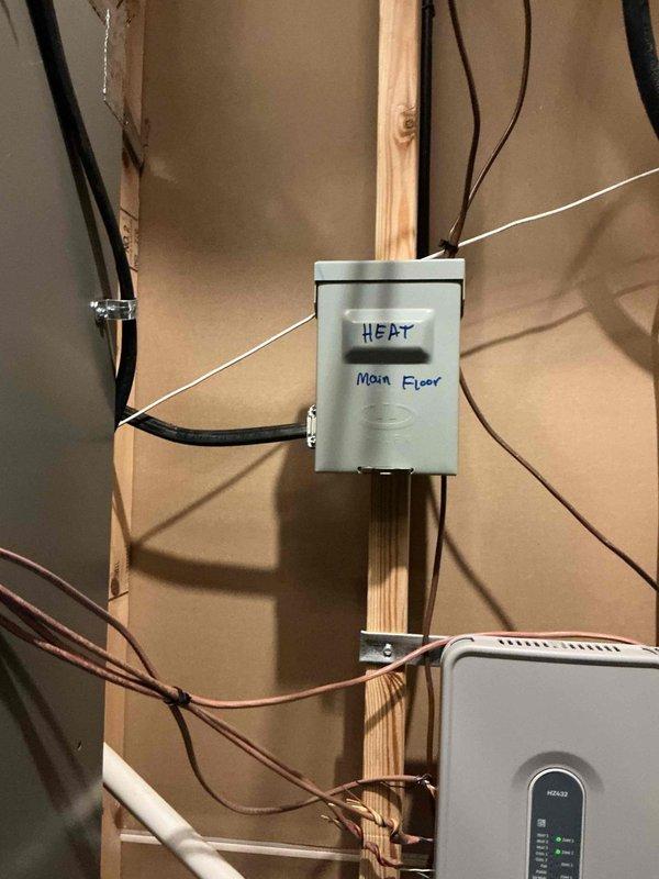Completed full HVAC heat pump installation at residential property. Installed outdoor condenser unit on concrete pad with proper clearances, mounted and wired electrical disconnect box on exterior wall, and ran refrigerant lines and electrical conduit through exterior siding. Interior work included installation and wiring of air handler unit in utility area, connection to existing electrical panel with dedicated circuit labeled for heating system and main floor zone, and integration with home's electrical infrastructure. All electrical connections completed to code specifications, refrigerant lines properly insulated and secured, and system tested for proper operation upon completion.