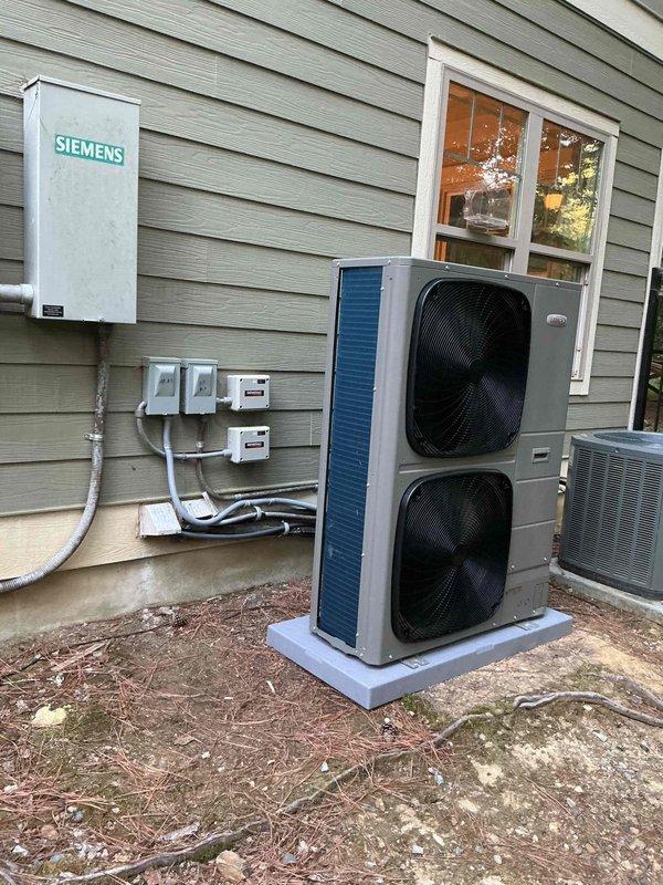 Completed full HVAC heat pump installation at residential property. Installed outdoor condenser unit on concrete pad with proper clearances, mounted and wired electrical disconnect box on exterior wall, and ran refrigerant lines and electrical conduit through exterior siding. Interior work included installation and wiring of air handler unit in utility area, connection to existing electrical panel with dedicated circuit labeled for heating system and main floor zone, and integration with home's electrical infrastructure. All electrical connections completed to code specifications, refrigerant lines properly insulated and secured, and system tested for proper operation upon completion.
