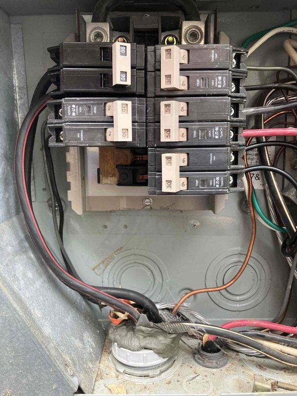 Completed comprehensive annual 32-point electrical system evaluation and preventative maintenance service. Performed electrical panel maintenance including proper torquing of all connections and thorough inspection of circuit breakers and bus bar system. Conducted GFCI outlet and breaker testing to verify shock protection functionality, along with arc fault breaker testing to ensure fire protection systems operating correctly. Provided smoke and CO2 detector maintenance services including battery replacement and operational testing. Replaced customer-supplied light bulbs in fixtures up to 12 feet and performed ceiling fan cleaning up to 12 feet. Documented electrical panel condition showing residential-style breakers in dual-column configuration with main power terminals and multiple circuit wiring. All safety devices tested and confirmed operational.