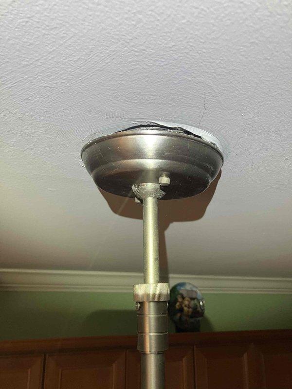 Responded to electrical service call for tripped breaker and chandelier appearing to disconnect from ceiling. Upon inspection, found ceiling-mounted light fixture with loose mounting hardware causing the fixture to hang lower than normal position. Verified electrical connections at junction box were secure, tightened fixture canopy and mounting rod assembly to ceiling plate, and confirmed proper fixture height and stability. Tested circuit breaker and fixture operation—all components functioning properly with no further tripping issues observed.