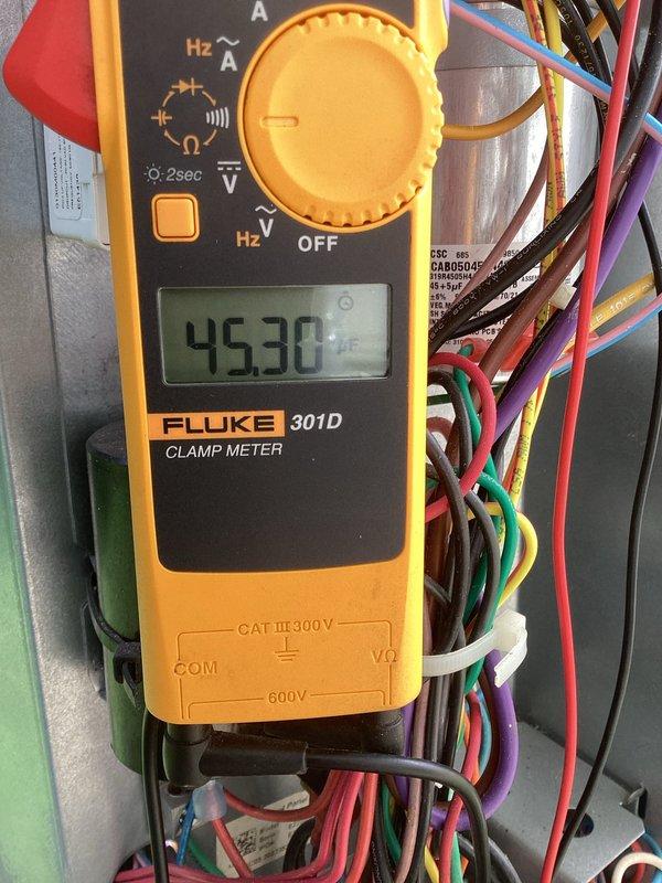 Completed comprehensive tune-up on 4-year-old HVAC system including standard maintenance procedures and diagnostics. Vacuumed condensate drain pan to address recurring shutdown issue caused by water accumulation, ensuring proper drainage and preventing future safety switch activations. Measured system pressures with digital manometer reading 03 and verified electrical draw at 45.30 amps using clamp meter, confirming unit is operating within normal parameters.