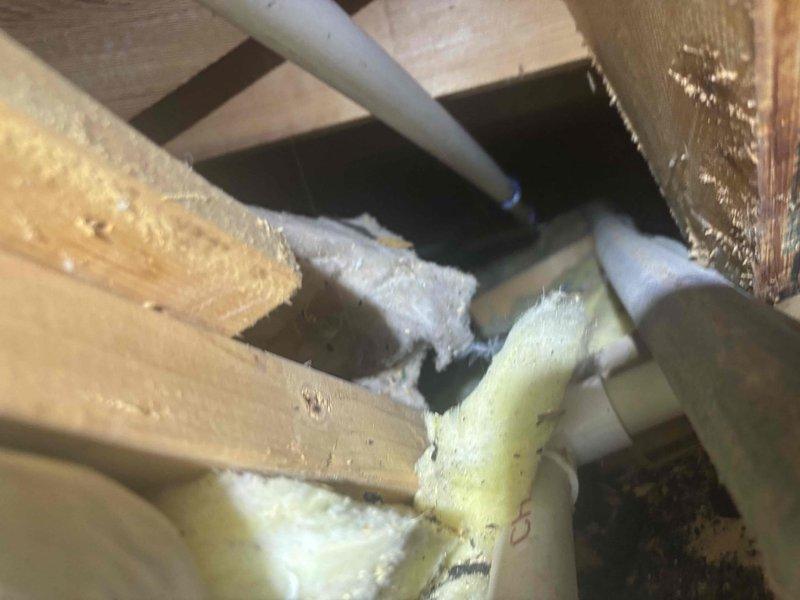 Responded to service call for HVAC system failing to maintain temperature and experiencing intermittent operation. Upon arrival, customer reported unit would start when thermostat was adjusted to lower settings but would subsequently shut down, resulting in indoor temperatures reaching 80 degrees. Conducted system inspection including attic-mounted equipment and exterior components. Documented existing conditions of refrigerant lines showing deteriorated foam insulation on linesets in attic space, along with exterior utility chase area containing multiple service lines and debris accumulation. System exhibited cycling issues consistent with potential safety switch activation or control malfunction requiring further diagnostic evaluation.