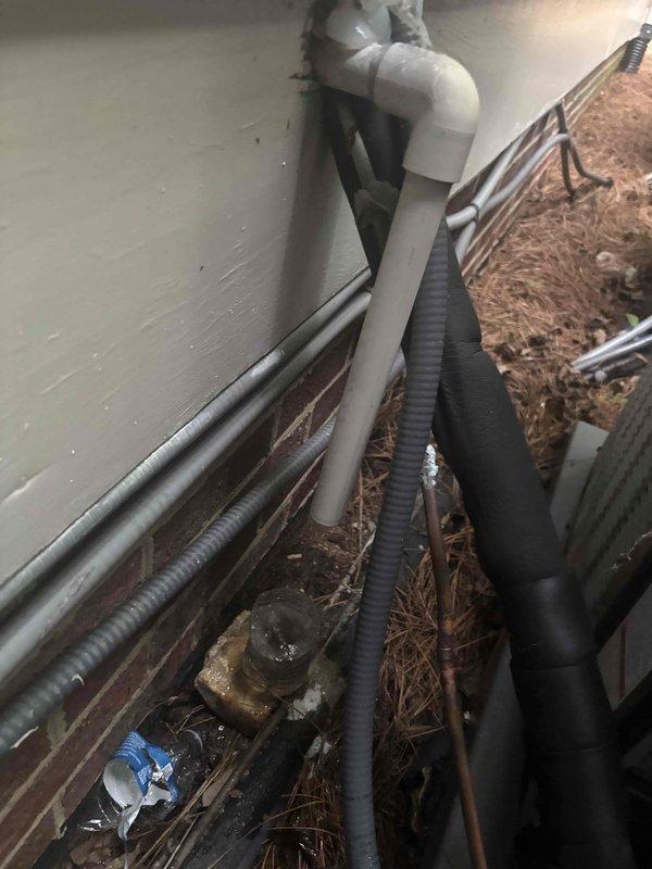 Responded to service call for HVAC system failing to maintain temperature and experiencing intermittent operation. Upon arrival, customer reported unit would start when thermostat was adjusted to lower settings but would subsequently shut down, resulting in indoor temperatures reaching 80 degrees. Conducted system inspection including attic-mounted equipment and exterior components. Documented existing conditions of refrigerant lines showing deteriorated foam insulation on linesets in attic space, along with exterior utility chase area containing multiple service lines and debris accumulation. System exhibited cycling issues consistent with potential safety switch activation or control malfunction requiring further diagnostic evaluation.