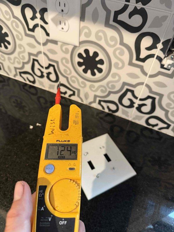 Responded to return visit for recurring under-cabinet lighting issue in kitchen. Upon arrival, inspected previously serviced under-cabinet LED/fluorescent light fixture mounted beneath upper cabinetry above decorative tile backsplash. Performed voltage testing at associated electrical outlet using multimeter, confirming proper 120V supply to circuit. Troubleshot fixture wiring connections, switch operation, and power supply to identify root cause of intermittent lighting failure. Made necessary repairs to ensure reliable operation and prevent future recurrence of the same issue.