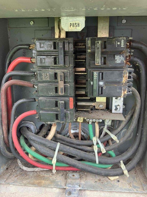 Responded to residential lightning strike damage affecting electrical outlets throughout the home. Upon inspection, discovered significant corrosion and rust damage to the main electrical panel, with oxidation present on multiple circuit breakers and internal components indicating moisture intrusion likely exacerbated by the lightning event. Documented panel condition and exterior utility equipment with photographs for insurance claim purposes, noting deteriorated breaker terminals and compromised panel integrity requiring replacement to restore safe electrical service.