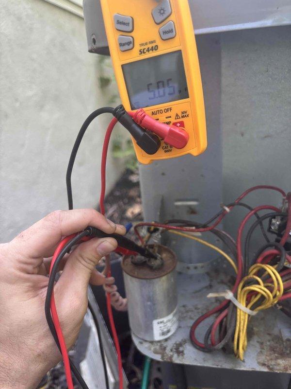Completed comprehensive heating and air maintenance on 7-year-old system including full 80-point inspection on all units. Performed outdoor coil cleaning, burner cleaning, and adjusted gas pressures to manufacturer specifications. Conducted electrical diagnostics on outdoor unit control panel, verifying proper voltage readings of 24.9V at control circuit and checking capacitor performance with multimeter showing 9.05 reading. All safety inspections passed and system operating within normal parameters.