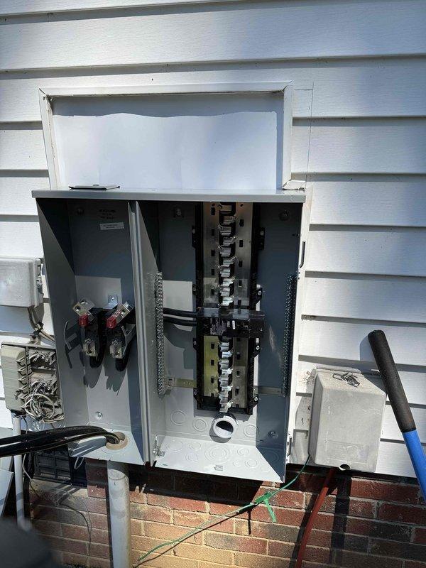 Disconnected existing meter and reconnected service with installation of new 200 amp meter/panel combination unit featuring copper busbars and complete circuit breaker replacement. Installed code-compliant grounding system with dual ground rods and integrated whole home surge protection device. All circuits were properly identified and labeled for major appliances including oven, water heater, HVAC system, dryer, dishwasher, and receptacles throughout all rooms. Applied weatherproof flashing around exterior panel installation to ensure weather-tight seal against vinyl siding. Work was completed under permit and qualifies as capital improvement, with all installations meeting current electrical code requirements.