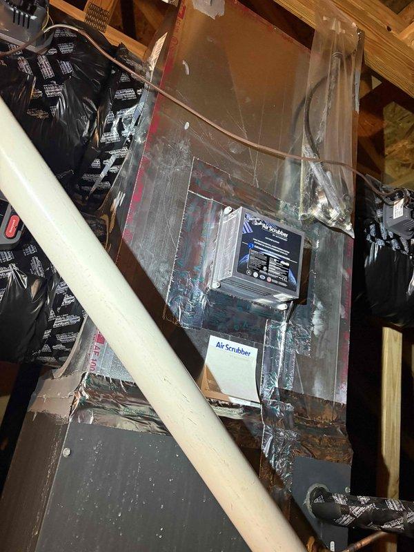 Completed installation of two air purification systems with media filter cabinets and IWAVE units in attic-mounted HVAC systems. Both units were successfully integrated into existing ductwork with proper mounting, electrical connections verified, and all components tested for proper operation upon completion.