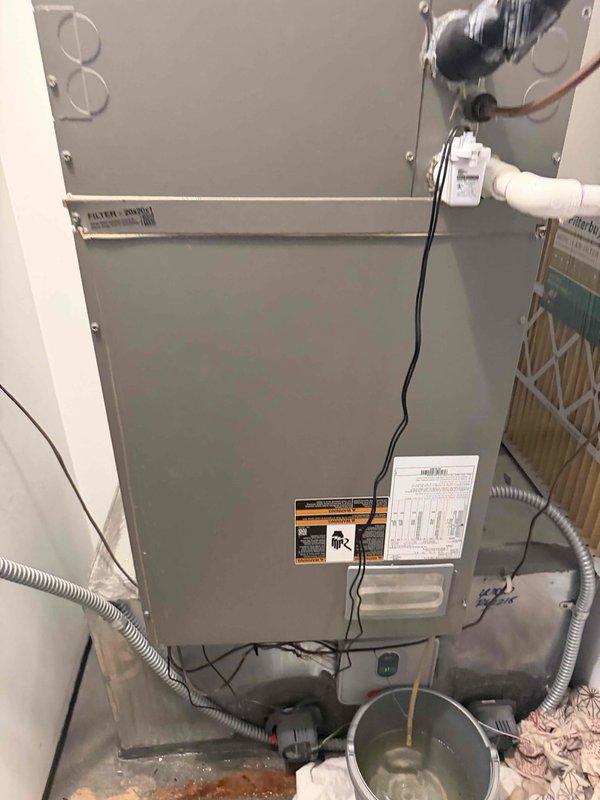 Responded to service call for 9-year-old single-system HVAC unit reported to be blowing warm air. Performed diagnostic inspection of vertical air handler unit and associated electrical components, including disconnect box and safety controls. Documented equipment condition with photos of unit installation, refrigerant lines, condensate drainage, air filtration, and electrical connections for system quote preparation.