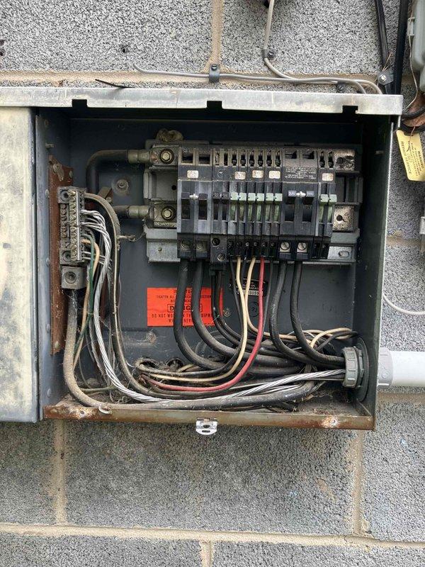 Responded to service call at 1973-built residence for multiple electrical installations. Assessed and repaired non-functioning light fixture in bathroom laundry closet area requiring ladder access due to elevated ceiling height. Installed lighting solutions in three separate bedroom closets to provide adequate illumination in previously dark storage spaces. Installed exterior weatherproof receptacle outlet to eliminate need for running extension cords through kitchen window. Inspected main electrical panel and exterior disconnect box to verify adequate capacity and proper circuit protection for new installations.