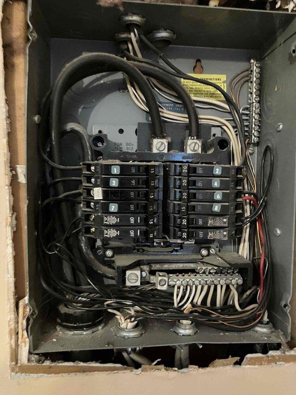 Responded to service call at 1973-built residence for multiple electrical installations. Assessed and repaired non-functioning light fixture in bathroom laundry closet area requiring ladder access due to elevated ceiling height. Installed lighting solutions in three separate bedroom closets to provide adequate illumination in previously dark storage spaces. Installed exterior weatherproof receptacle outlet to eliminate need for running extension cords through kitchen window. Inspected main electrical panel and exterior disconnect box to verify adequate capacity and proper circuit protection for new installations.