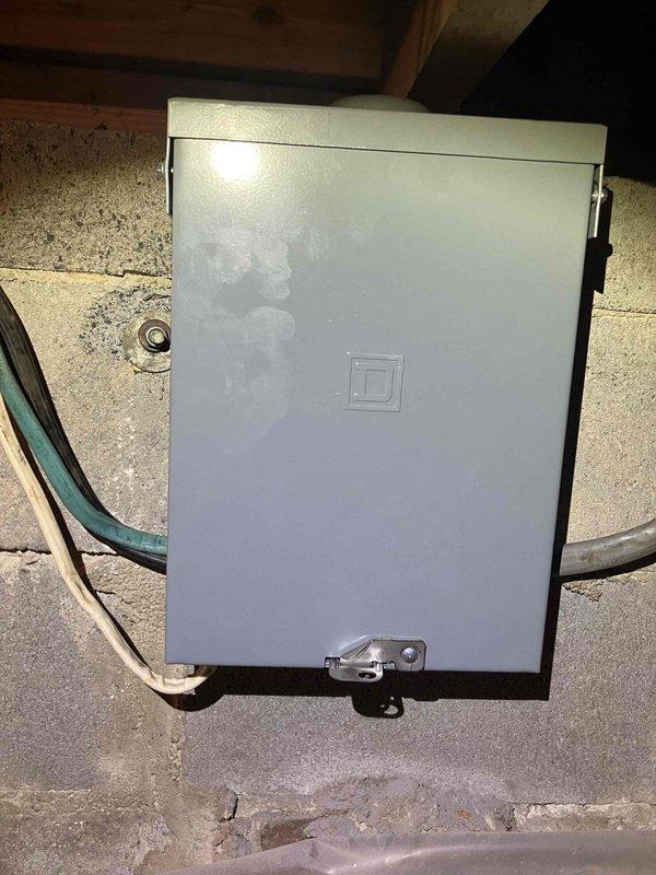 Responded to no cooling call and discovered severely damaged subpanel with compromised breaker showing evidence of electrical failure and thermal damage. Upon inspection in crawlspace, found burned and melted metal casing on subpanel with exposed internal wiring and significant charring around breach point. Documented extensive damage to electrical panel box and surrounding components with photographs for assessment. Breaker exhibited signs of overheating and failure, requiring immediate attention to restore safe operation of single HVAC system in residence.
