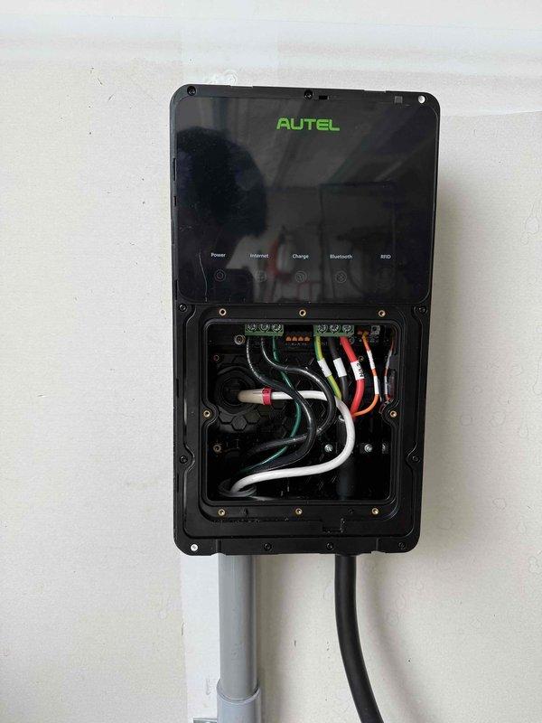 Completed installation of a new Autel electric vehicle charging station with hardwired connection to the electrical system. Installed weatherproof junction box with proper wire terminations using terminal blocks and wire connectors, ensuring all conductors were securely fastened and color-coded per electrical standards. Mounted the Autel charger unit to interior wall, connected all power and control wiring through conduit, and verified proper operation of all functions including power, internet connectivity, charging capability, Bluetooth, and RCD safety features.