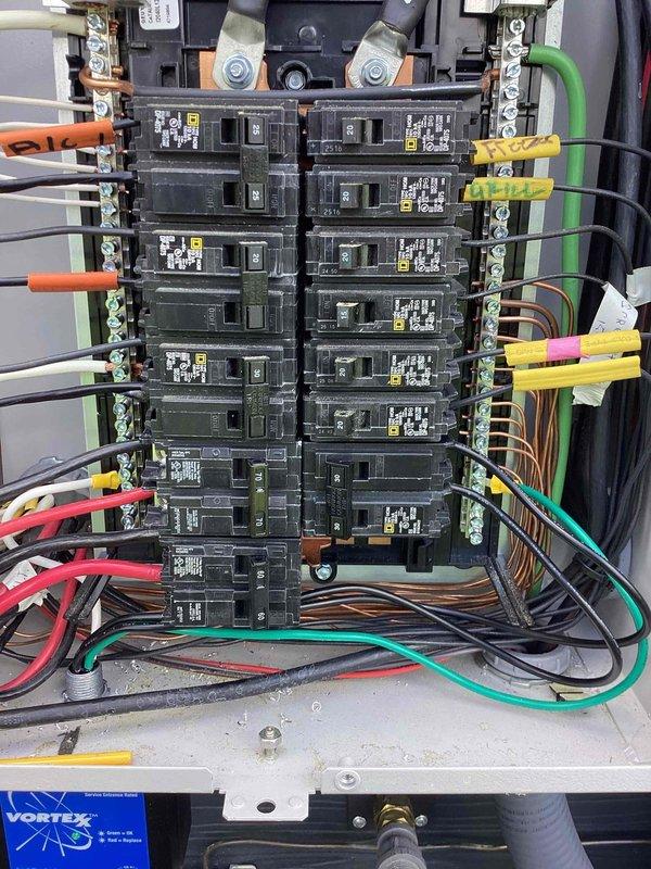 Installed two new electrical outlets in the garage per customer request. Inspected the 400-amp electrical service and main panel configuration in response to utility company concerns regarding surge protector compatibility. Documented existing panel layout showing dual columns of circuit breakers with multiple dedicated circuits including HVAC, well pump, hot tub, and other loads, with all circuits properly labeled and organized.