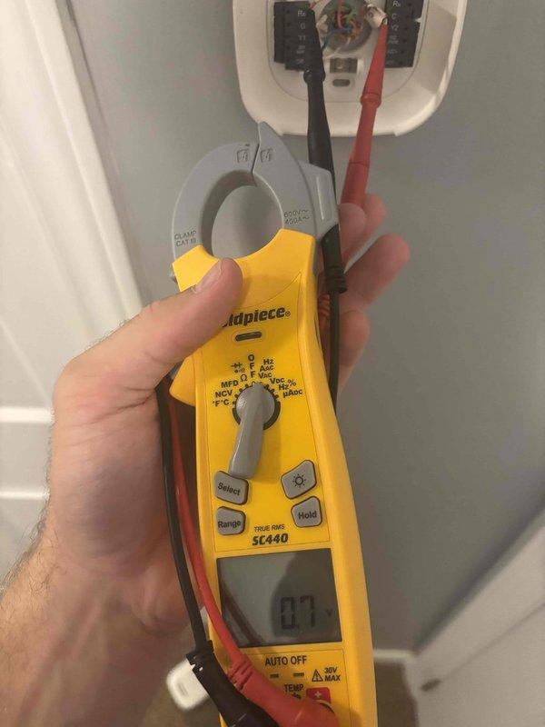 Responded to no cooling complaint on upstairs HVAC system with intermittent power loss to Ecobee thermostat. Upon arrival, found air handler experiencing complete power interruption cycles lasting multiple days. Inspected air handler evaporator coil assembly and electrical connections. Testing revealed faulty or loose electrical connection affecting system power supply. Used clamp meter to verify amperage draw and diagnose electrical circuit integrity at air handler. Identified power supply issue causing random system shutdowns and loss of thermostat communication. Recommended electrical repairs to restore consistent power delivery to air handler and thermostat for proper system operation.