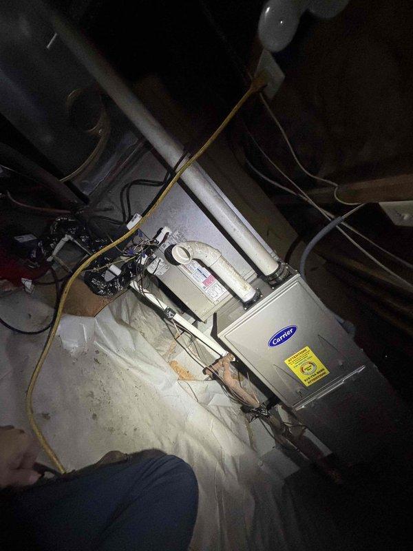 Responded to service call for upstairs system not maintaining temperature with hot air discharging from top of outdoor unit. Upon arrival, customer declined to power down system despite advisement that frozen coil conditions would prevent proper diagnosis and repair. Performed electrical diagnostics on outdoor condenser unit using clamp meter to test capacitor, contactor, and compressor circuits. Inspected indoor air handler and associated refrigerant lines in basement installation. Unable to complete full system evaluation or perform necessary repairs due to unit remaining energized and potential ice buildup on evaporator coil preventing access to refrigerant system components.