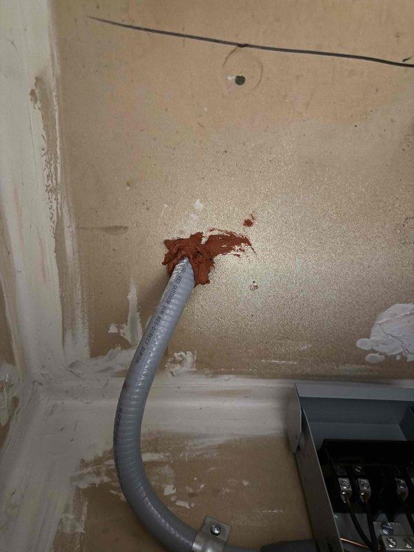 Installed dedicated electrical circuit for HVAC system, running new conduit through interior wall and connecting circuit breaker in main electrical panel. Routed gray flexible conduit from panel to HVAC location, secured all connections per code requirements, and verified proper circuit operation upon completion.
