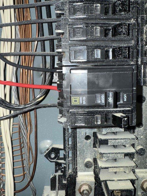 Installed dedicated electrical circuit for HVAC system, running new conduit through interior wall and connecting circuit breaker in main electrical panel. Routed gray flexible conduit from panel to HVAC location, secured all connections per code requirements, and verified proper circuit operation upon completion.