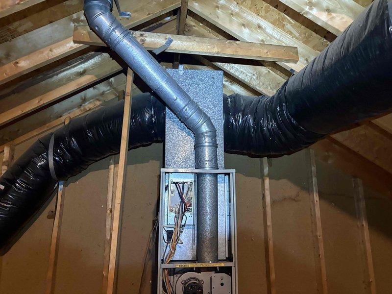 Responded to no-cool complaint where system was blowing air but failing to reach thermostat setpoint. Upon inspection, found air handler in attic with severely restricted airflow due to heavily clogged air filter loaded with dust and debris. Replaced dirty filter to restore proper airflow and system cooling capacity. System tested and confirmed operating within normal parameters with adequate temperature drop across evaporator coil.