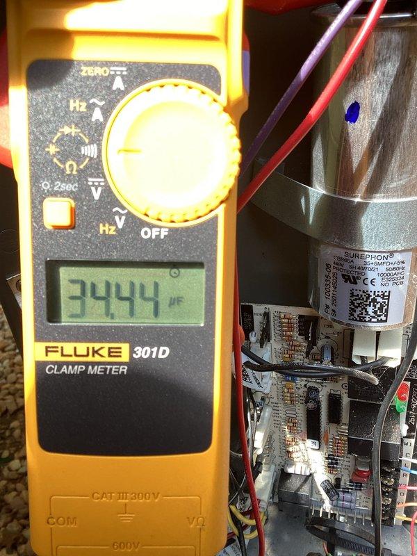 Responded to no cooling call on 1-year-old system with thermostat not powering on following power outage. Upon inspection, tested electrical components using clamp meter and found capacitor reading 3444 μF, indicating failed run capacitor causing system shutdown. Measured current draw at 7.50A on blower motor circuit and verified all electrical connections at control board and gas valve assembly, replaced defective capacitor, restored power to thermostat and system, and confirmed proper operation of cooling cycle.