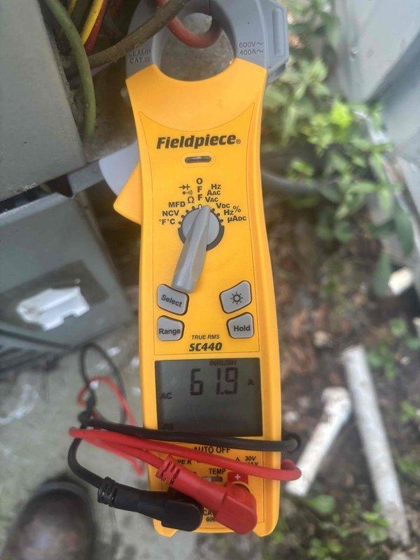 Responded to service call for 10-year-old HVAC system with multiple concerns. Inspected condensate drain line beneath house, found muddy accumulation and slime buildup indicating biological growth. Cleared drain line obstruction and verified proper drainage flow. Investigated pantry ductwork where homeowner had discovered organic growth and air gap between duct boot and exterior siding. Confirmed homeowner's foam sealant application was adequate and verified no additional air infiltration from attic space. Inspected attic-mounted air handler and associated equipment for overall condition. Tested system electrical components and verified capacitor reading of 619 MFD on outdoor condensing unit. Despite system age, unit is currently operational and homeowner declined replacement recommendation at this time. All immediate concerns addressed and system returned to normal operation.