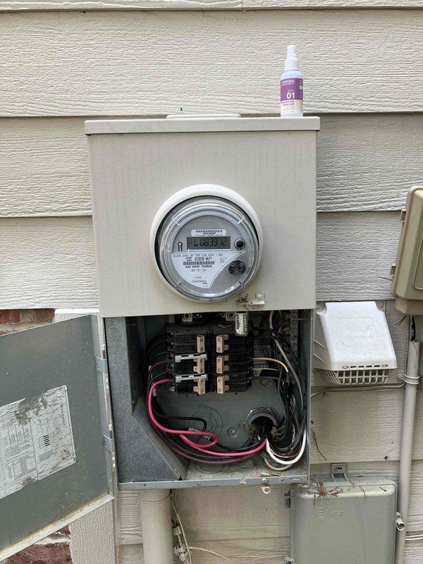 Responded to electrical service call at 2005-built residence where homeowner accidentally drilled through drywall in upstairs laundry room and struck electrical cable feeding circuit from main panel located directly below. Inspected damaged cable through access opening, verified no immediate power loss to home, confirmed no tripped breakers or flickering lights, and examined main electrical panel and meter for any signs of fault or partial service interruption. Documented damage to NM cable within wall cavity and recommended licensed electrician perform cable repair/replacement to restore safe operation of affected circuit.