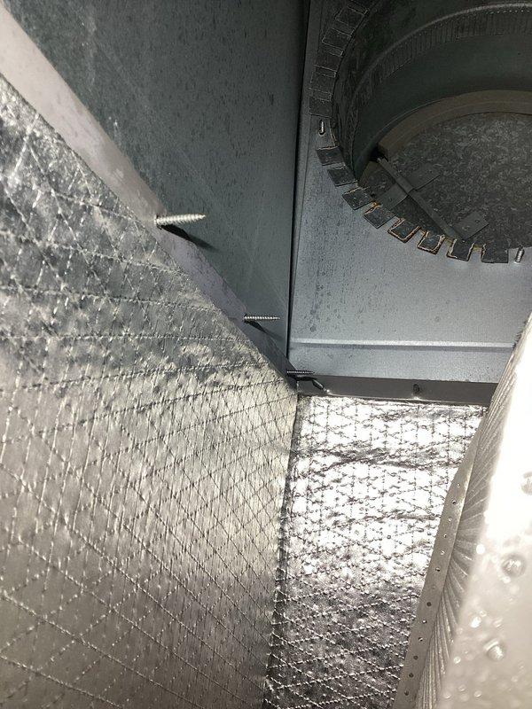Responded to customer complaint of dirty sock smell from vents following recent maintenance visit. Performed thorough inspection of air handling system and evaporator coil assembly. Upon examination, discovered moisture and biological growth on blower wheel assembly, confirmed by visual inspection showing dark, glossy substance on center hub. Inspected ductwork connections and insulation for proper installation and potential moisture sources. Documented conditions with photographs showing blower wheel contamination and duct connections. Verified all components from previous maintenance work were properly installed and not contributing to odor issue. Recommended blower wheel cleaning and potential evaporator coil treatment to eliminate odor source.
