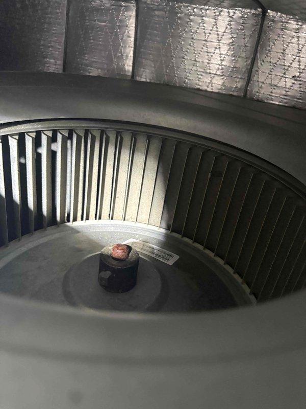 Responded to emergency service call for active water leak coming through ceiling from attic-mounted HVAC system. Upon arrival, found significant water accumulation under air handler unit. Performed thorough inspection of 6-year-old system, including blower assembly and condensate drainage system. Identified source of leak related to condensate drain line failure, evidenced by water staining on attic floor near PVC drain piping. Documented system condition with photos showing blower assembly, air handler configuration, and drainage components. Advised customer of findings and provided recommendations for repair to prevent further water damage and restore proper system operation.