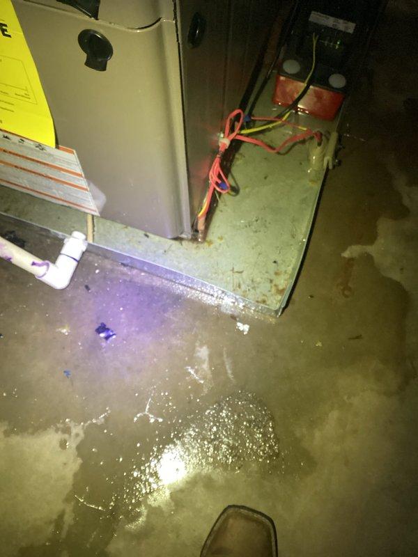 Responded to emergency after-hours call for non-operational air conditioning system. Upon arrival, discovered significant water accumulation in mechanical room surrounding air handler and condensate management equipment. Inspection revealed condensate pump failure causing drainage system malfunction and subsequent flooding of utility area. Accessed attic-mounted air handler unit and verified refrigerant lines and internal components for proper operation. Identified failed condensate pump as root cause preventing AC system operation due to safety float switch activation. Addressed immediate water intrusion issue and restored condensate drainage functionality to return system to operational status.