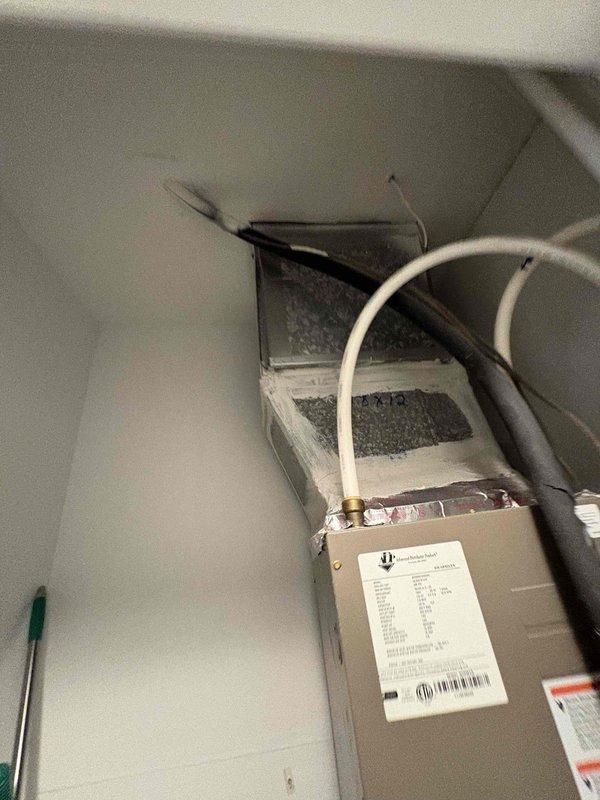 Responded to no cooling complaint on 4-year-old system where indoor blower was operational but outdoor condenser fan was not running. Performed diagnostic testing at air handler and outdoor unit using electrical meter to verify power supply and component operation. Measured voltage readings at outdoor unit showing 21.77 volts, indicating potential capacitor failure or compressor/fan motor electrical issue preventing proper condenser fan operation, resulting in loss of cooling capacity.