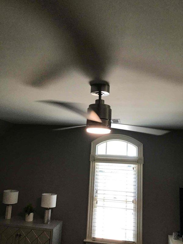 Installed customer-provided in-wall fan control switches and standard toggle switches in a triple-gang configuration on interior wall. Mounted combination switch plate covers to complete the installation, providing operational control for ceiling-mounted fan unit with integrated lighting fixture.