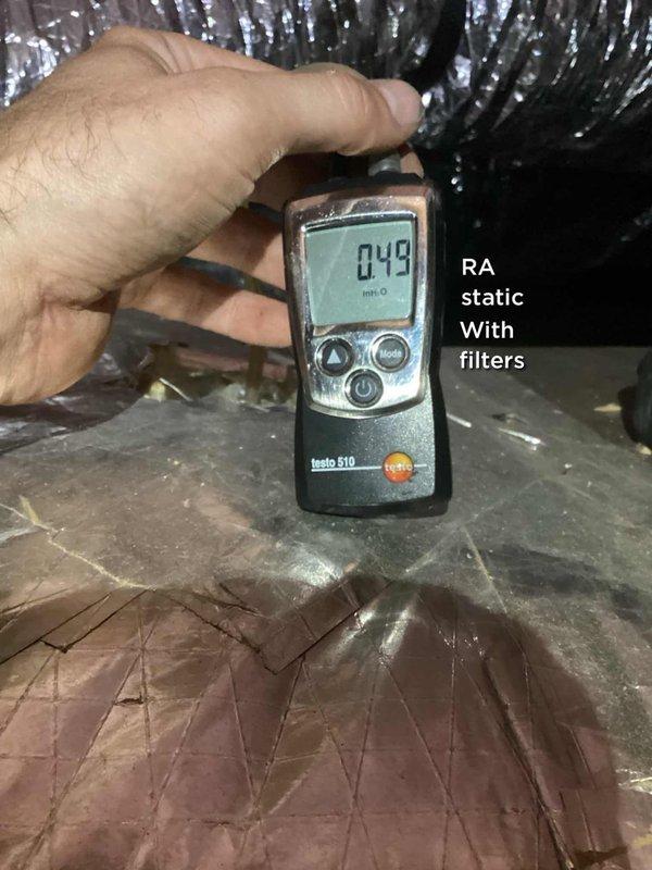 Responded to service call for thermostat malfunction causing cooling system to stop functioning between 7 PM and 3 AM for approximately one week. Performed diagnostic testing of 10-year-old HVAC system, including static pressure measurements which registered 0.49 inches with filters installed. Inspected condensate drain system and found standing water in drain pan, indicating potential blockage affecting system operation. Cleared condensate line obstruction and verified proper drainage to restore normal system cycling and eliminate time-specific cooling interruption.