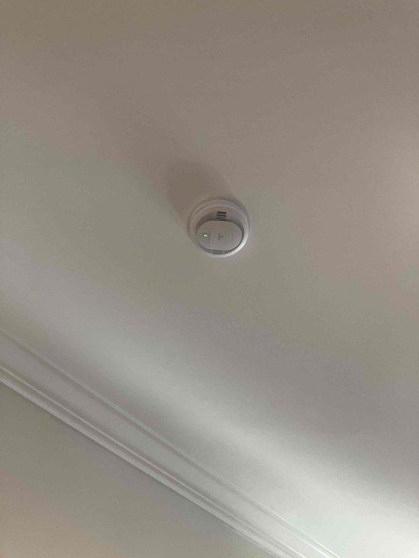 Replaced eight smoke detectors throughout the residence, including one unit located in the attic space. Homeowner provided all replacement detectors; verified compatibility and installed new mounting harnesses where required due to different base configurations between old and new units. Accessed attic area to remove existing detector and install new unit near HVAC ductwork, ensuring proper mounting and functionality. Completed installation of all seven remaining detectors on ceilings with maximum height of nine feet throughout living areas. Tested all units for proper operation and confirmed alarm functionality upon completion.