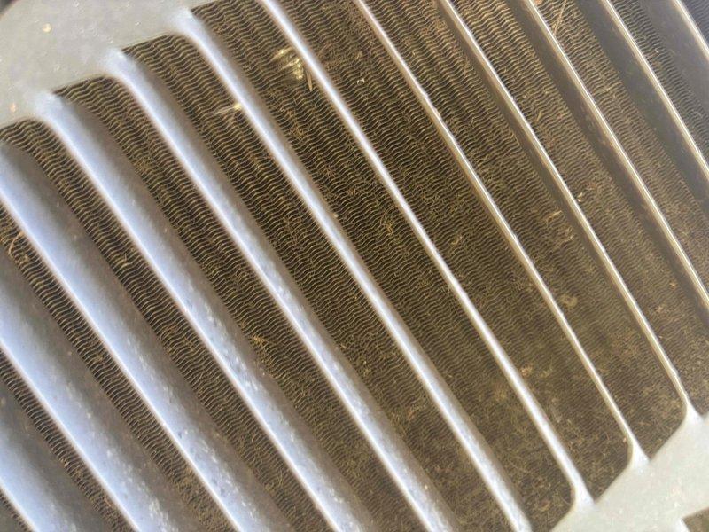 Responded to no cooling call where system was not turning on. Upon arrival, performed diagnostic testing using multimeter and measured 5.02 volts at electrical components. Inspected evaporator coil and found significant dirt and debris accumulation on fin surfaces, particularly on one side, which was restricting airflow and system performance. Documented equipment condition with photos showing contaminated coil requiring cleaning and electrical measurements for further troubleshooting of power supply issues preventing unit operation.