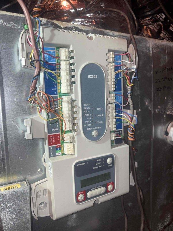 Responded to no airflow complaint on 32-year-old system. Upon inspection, found HZ322 zone control panel in attic with multiple zone wiring connections intact and control board displaying proper indicator lights. Verified zone control board functionality, checked all wire terminations at terminal strips, and confirmed proper communication between thermostat and zone controller. System restored to normal operation with all zones responding appropriately.