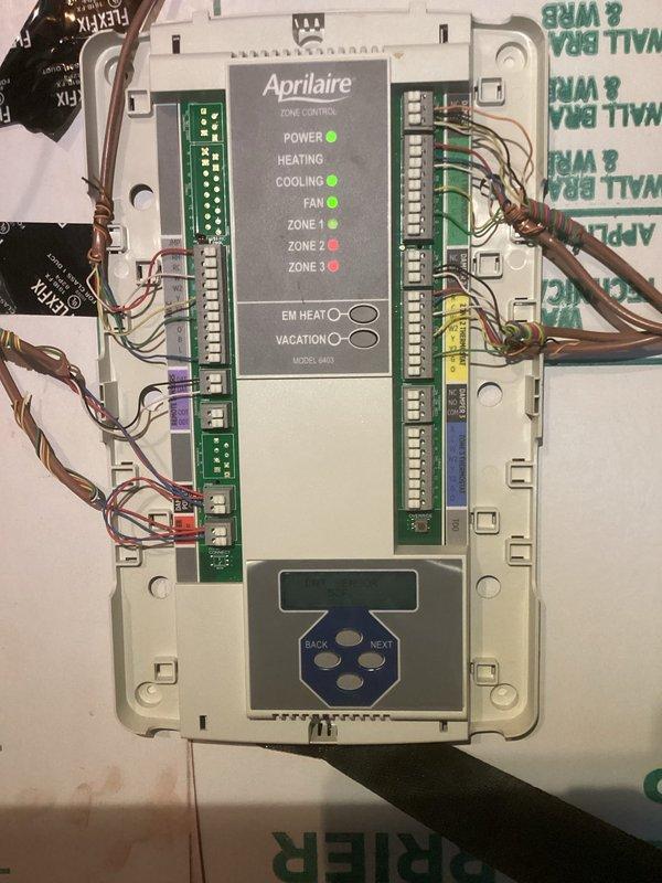 Performed second opinion evaluation on three-zone HVAC system with Aprilaire 8870 zone control panel following customer concerns regarding previous zone damper replacement work. Inspected attic ductwork installation including multiple zone dampers with insulated flex duct connections and refrigerant line routing. Verified zone control panel wiring, power supply, and zone damper operation across all three zones to assess system functionality and identify any installation deficiencies from prior service provider.
