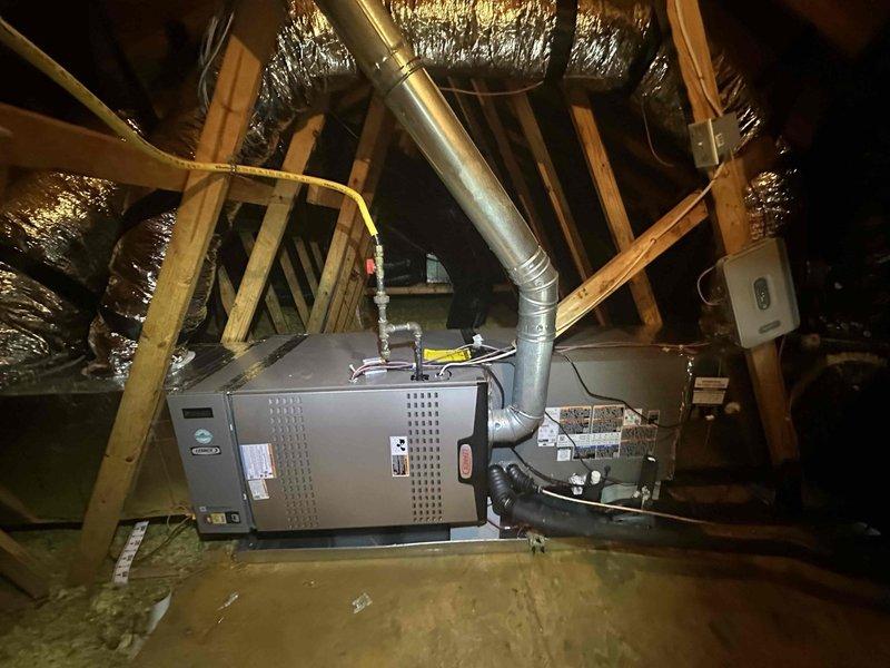 Completed full HVAC system replacement including removal of existing equipment and installation of new Lennox Elite 5-ton air conditioner (EL18KCV-060), Lennox CK40 5-ton evaporator coil, and Lennox Signature Series 90,000 BTU furnace (SL280V-90) in attic space. Installed Lennox E40 programmable thermostat for system control and integrated air quality improvements including Aprilaire 1110 media air cleaner and TRADEPRO germicidal UVC light kit for enhanced filtration and microbial control. Added Intermatic AG3000 surge protector to safeguard equipment from electrical damage.

Installation work included setting new outdoor condenser pad, running and securing metallic ductwork from furnace unit through attic space, and installing emergency drain pan with float switches for condensate overflow protection. Applied reflective insulation to ductwork where needed and ensured proper ventilation clearances around equipment. Completed all electrical connections, refrigerant line sets, and conden