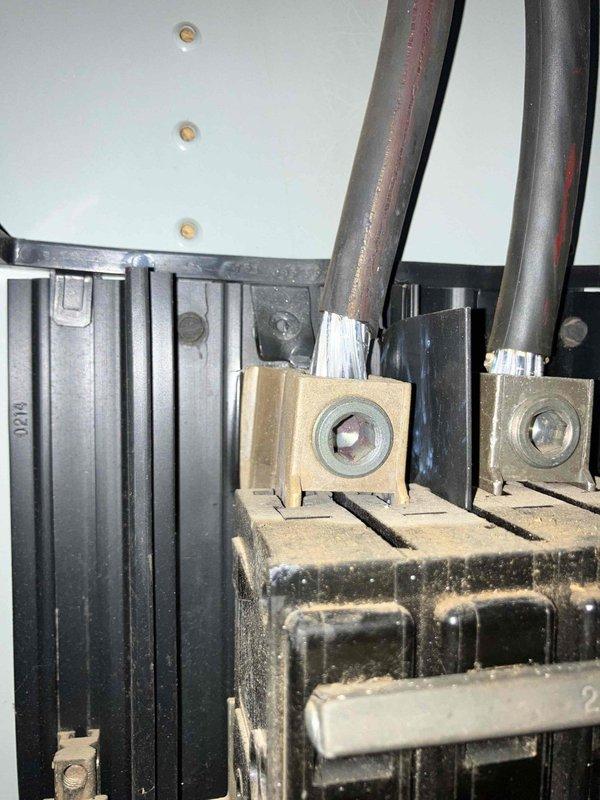 Responded to a power outage at a 1984 residence where the utility company identified a hot spot at the meter box and disconnected power at the transformer. Upon arrival, confirmed total power loss to the home with reports of prior flickering lights and tripped breakers. Inspected the exterior meter base and electrical service entrance components, documenting oxidized and discolored bus bar terminals showing signs of overheating and age-related deterioration. Photographed the compromised electrical connections and meter socket assembly for utility company coordination and recommended immediate replacement of the meter base assembly due to failed connections creating the thermal event.