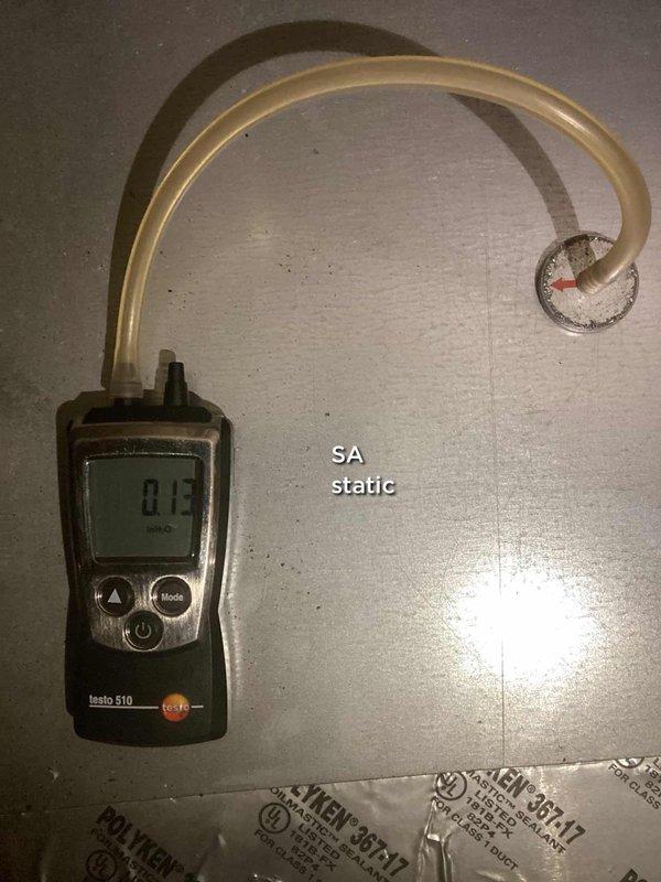 Responded to no-cooling complaint for upstairs central air conditioning system. Located upstairs furnace/air handler in unfinished attic space and performed diagnostic testing. Measured supply air static pressure using calibrated digital manometer, recording 0.5 mbar reading to assess system airflow and blower operation. Identified and documented equipment location for future service reference, noting upstairs unit serves second floor cooling zone.