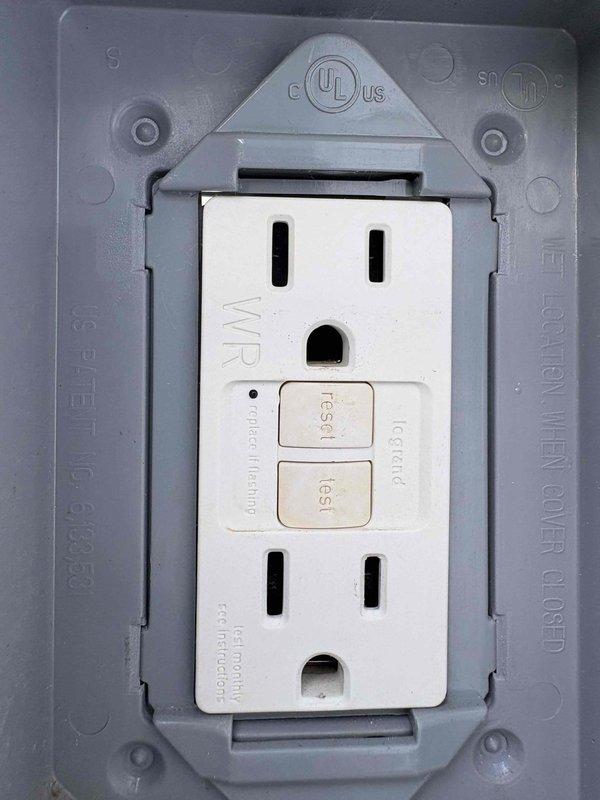 Responded to reported GFCI outlet issue at exterior garage location controlling pool lighting circuit. Performed comprehensive testing of weather-resistant GFCI receptacle using Klein Tools RT250 outlet tester, which confirmed proper voltage (12.1V reading displayed) and correct wiring configuration with functioning ground fault protection. GFCI outlet tested successfully with no faults detected, reset and test buttons operating within normal parameters, and weatherproof cover intact and properly sealed for outdoor installation.