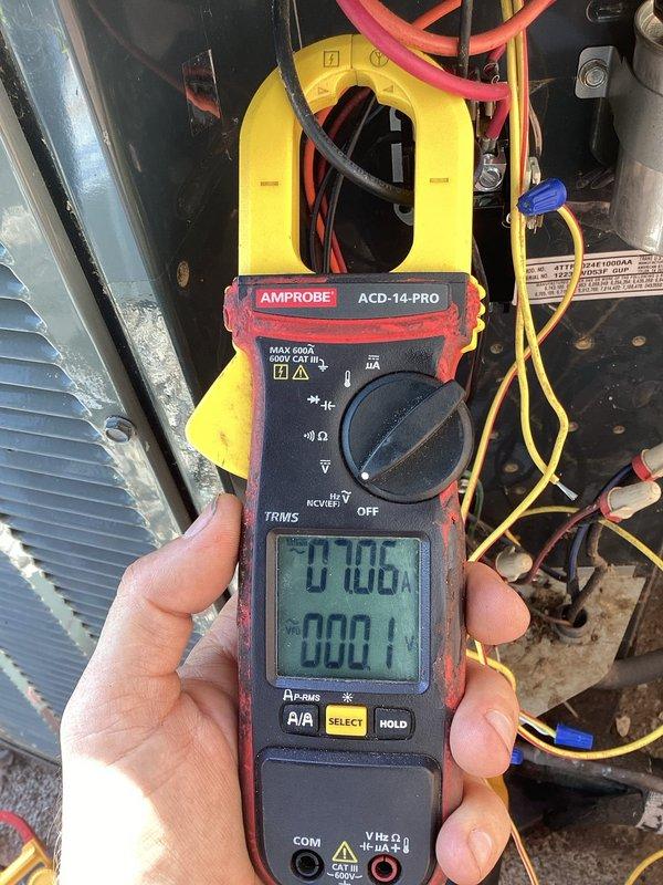Responded to no cooling complaint on 10-15 year old central air system. Found customer had bypassed pressure switch due to suspected voltage loss across switch. Upon inspection, discovered evaporator coil completely frozen with heavy ice buildup throughout interior cabinet. Measured compressor amperage at 1.0A using clamp meter, confirming system operation. Diagnosed frozen coil condition caused by restricted airflow or low refrigerant charge, which resulted in pressure switch opening as safety mechanism to prevent compressor damage. Advised customer that bypass of pressure switch is unsafe and must be removed, as switch protects system from operating under unsafe conditions that caused freezing issue.