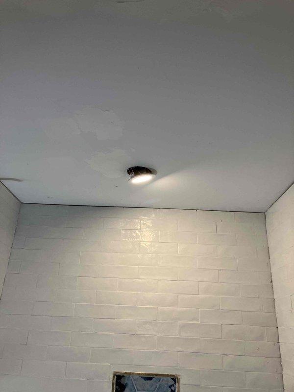 Completed bathroom electrical upgrade including installation of new switches and GFCI outlets with finished cover plates. Installed two customer-supplied vanity light fixtures with brass-toned sconces and frosted glass shades, along with a 4" slimline recessed can light above the shower area in the tiled enclosure. Supplied and installed a fire protection breaker to properly protect the multi-wire branch circuit serving the bathroom. All work completed to code with three-year warranty on parts and labor, extended to five years with membership enrollment.